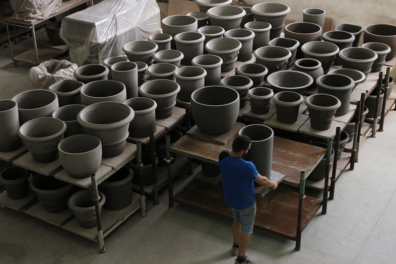 An Italian artisan crafting the rim of a pot